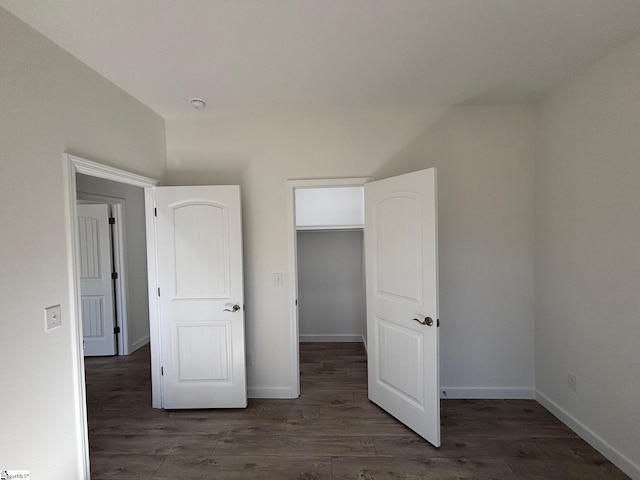 unfurnished bedroom with dark wood-style floors and baseboards