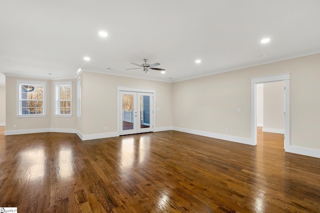 unfurnished living room featuring french doors, dark wood finished floors, and crown molding