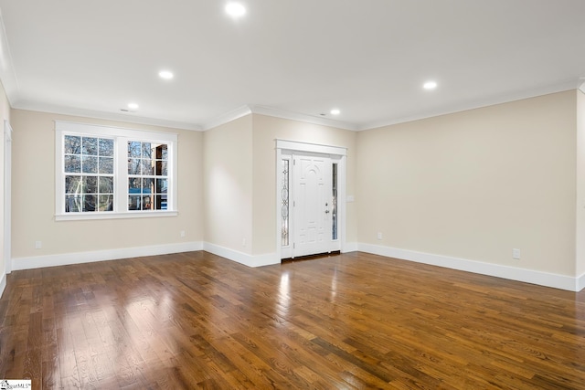 spare room with baseboards, ornamental molding, dark wood finished floors, and recessed lighting