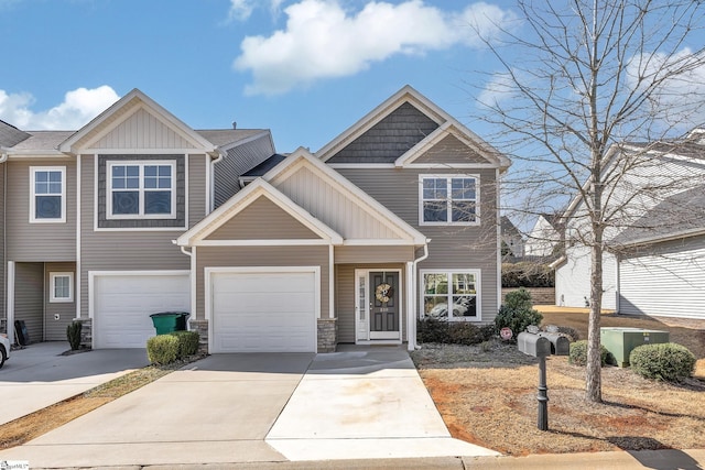 townhome / multi-family property featuring concrete driveway and board and batten siding