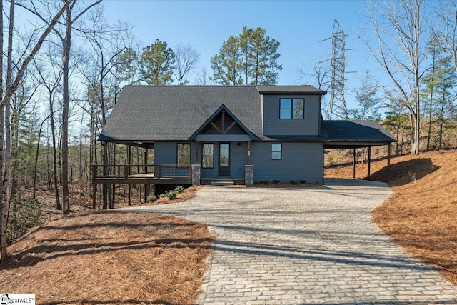 view of front facade featuring a carport and decorative driveway