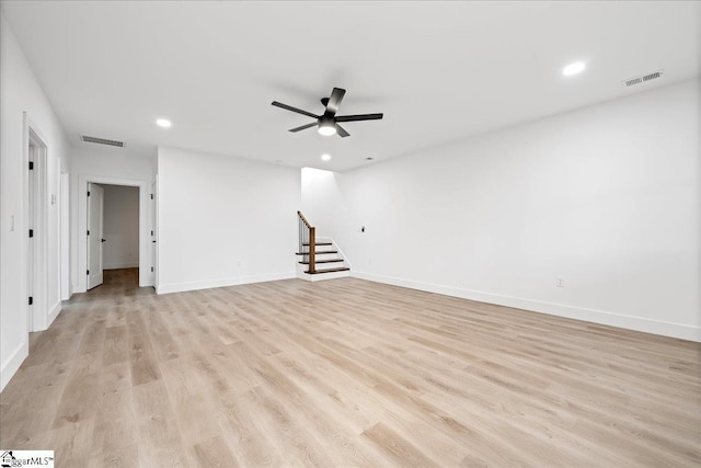 empty room featuring stairs, recessed lighting, visible vents, and light wood-style floors