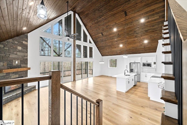 living area with high vaulted ceiling, wood ceiling, and light wood-style flooring