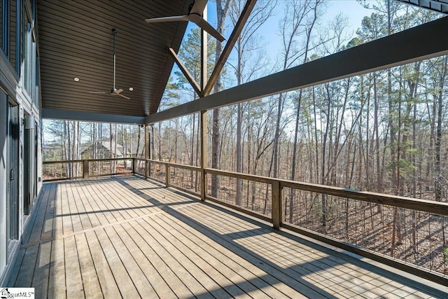 unfurnished sunroom featuring a ceiling fan