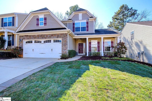 craftsman-style home with covered porch, stone siding, a front yard, and driveway