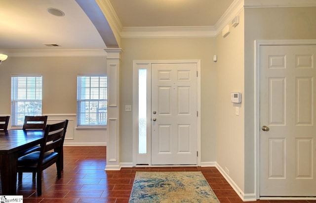 entrance foyer with arched walkways, wood finish floors, visible vents, ornamental molding, and ornate columns