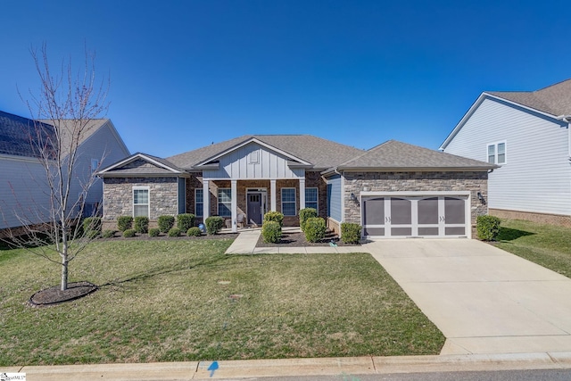 view of front of property with a garage, driveway, stone siding, a front lawn, and board and batten siding