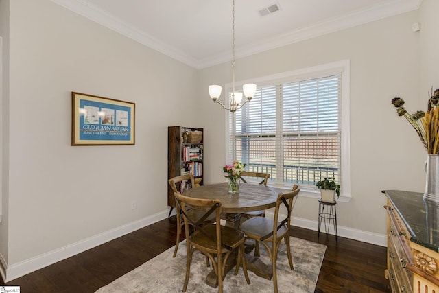 dining room featuring visible vents, baseboards, ornamental molding, dark wood finished floors, and an inviting chandelier