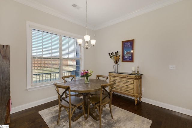 dining space featuring dark wood-style floors, crown molding, and baseboards