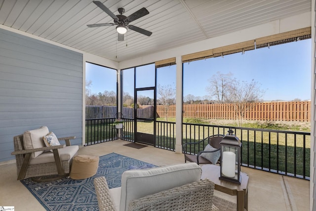 sunroom / solarium with a healthy amount of sunlight and a ceiling fan