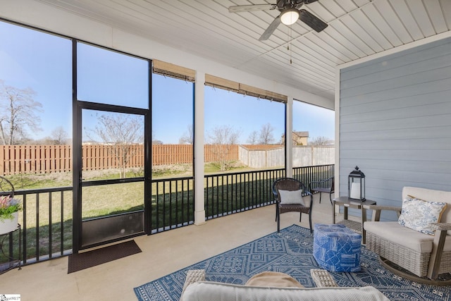 sunroom / solarium featuring ceiling fan