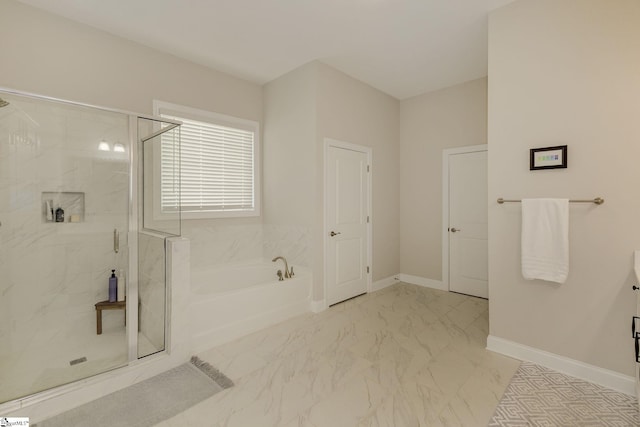 full bath with marble finish floor, baseboards, a bath, and a stall shower