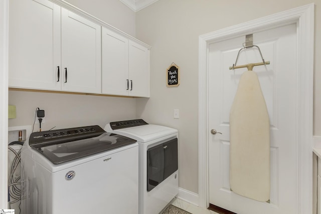 washroom featuring cabinet space, baseboards, and independent washer and dryer