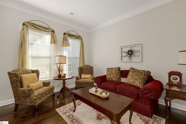 living room featuring ornamental molding, baseboards, and wood finished floors