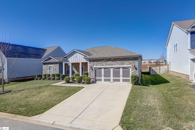 view of front of house with a garage, stone siding, board and batten siding, and a front yard