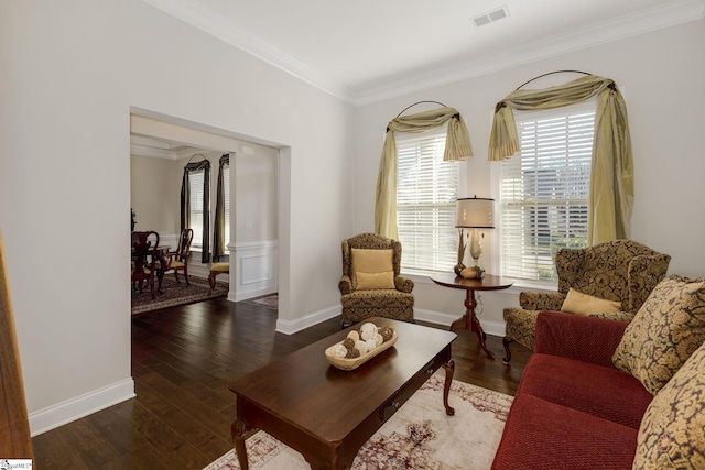 living area featuring ornamental molding, wood finished floors, visible vents, and baseboards