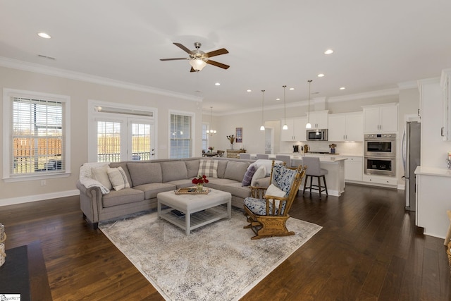 living room with baseboards, ornamental molding, and dark wood finished floors