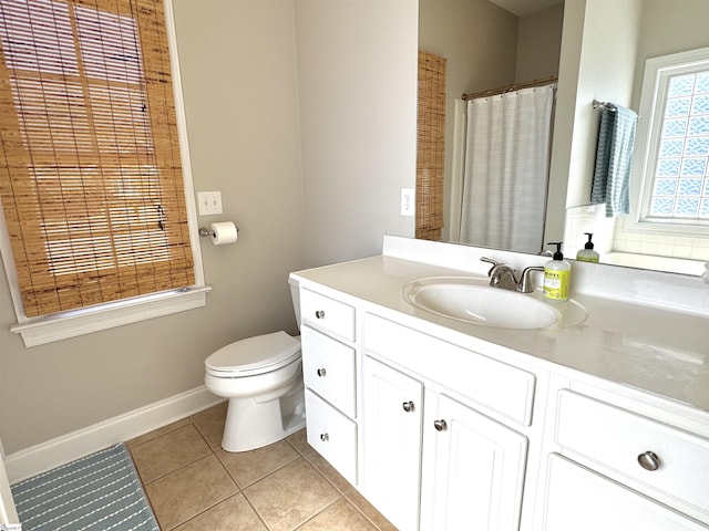 full bathroom featuring toilet, tile patterned flooring, baseboards, and vanity