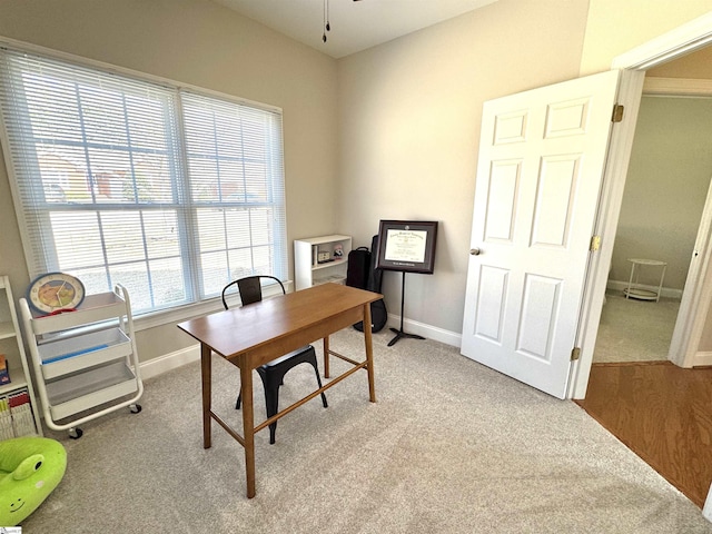 office area with light carpet and baseboards