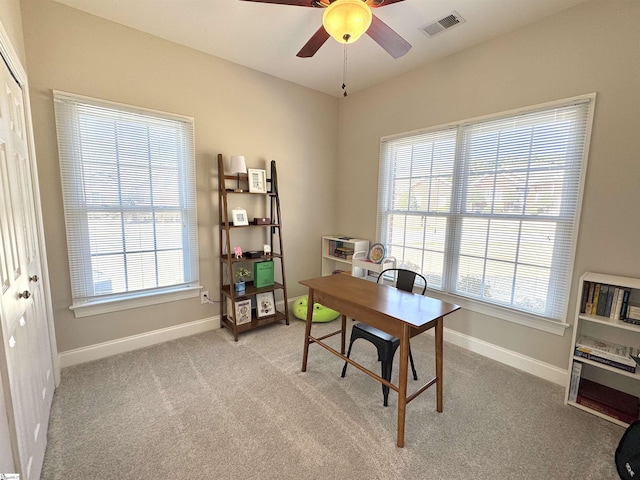 office with light carpet, baseboards, visible vents, and a wealth of natural light