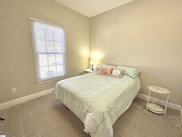 carpeted bedroom featuring baseboards