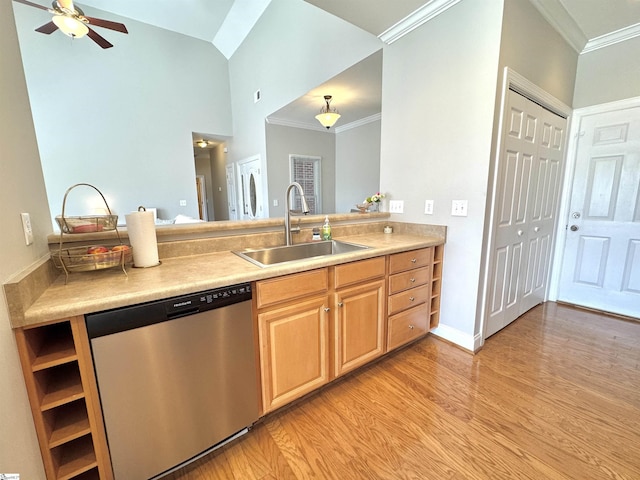 kitchen with light countertops, stainless steel dishwasher, a sink, and light wood-style flooring