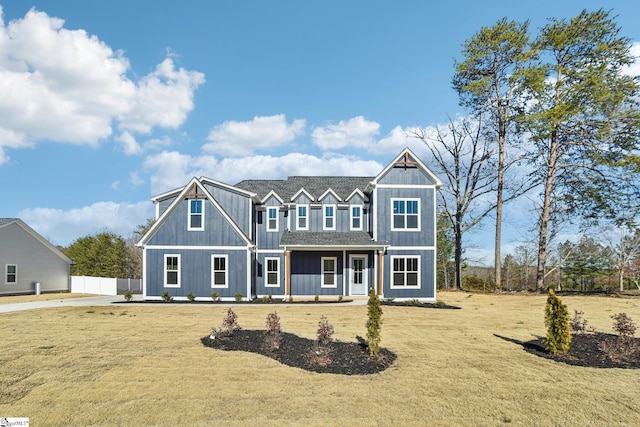 view of front of home featuring board and batten siding and a front yard