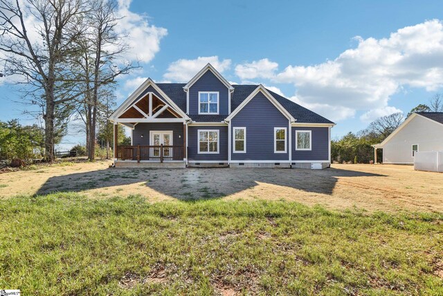 view of front facade with french doors and a front lawn