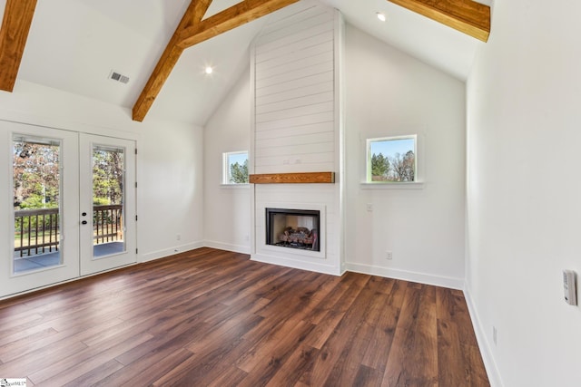 unfurnished living room with a large fireplace, beam ceiling, dark wood-style flooring, and visible vents