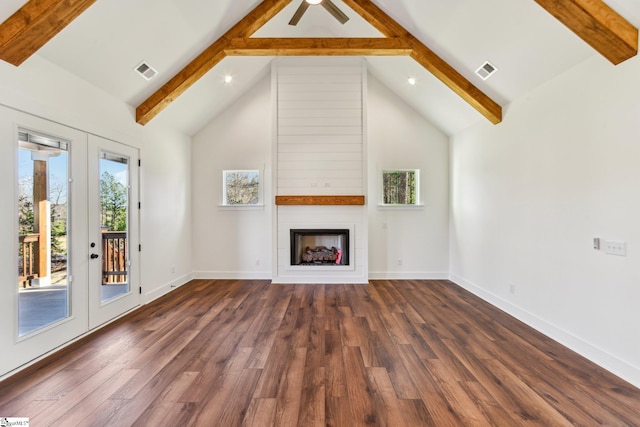 unfurnished living room with dark wood-type flooring, beamed ceiling, a fireplace, and visible vents