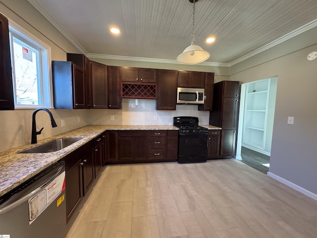 kitchen featuring stainless steel microwave, hanging light fixtures, black gas range, a sink, and dishwashing machine