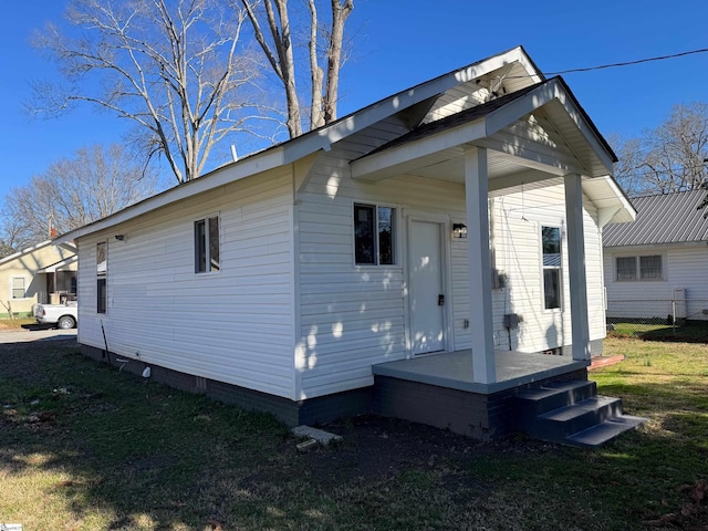 rear view of property with a yard