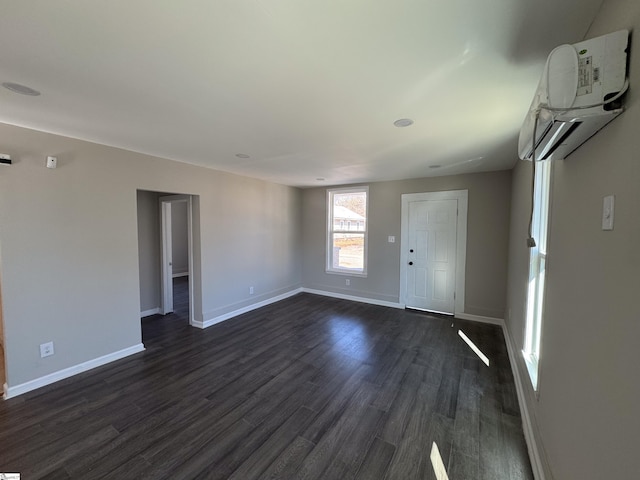 interior space with dark wood-type flooring and baseboards