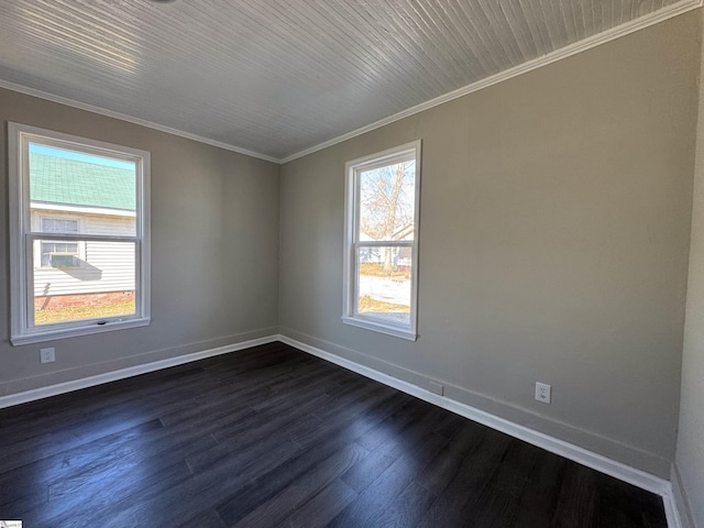 spare room featuring ornamental molding, baseboards, and dark wood-style floors