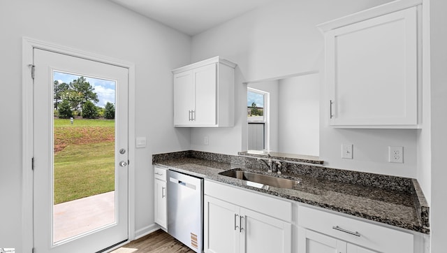 104 Sunriff Ct, Greer, SC 29651 - kitchen featuring stainless steel dishwasher, dark stone countertops, white cabinets, and light wood-type flooring