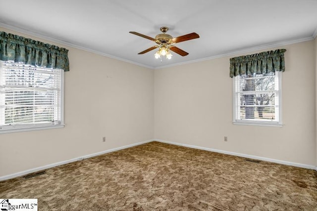 carpeted spare room featuring ceiling fan, ornamental molding, and baseboards