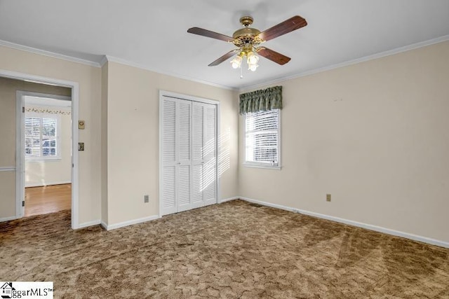 unfurnished bedroom featuring ornamental molding, a closet, and carpet flooring