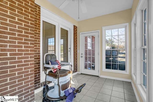 sunroom with a ceiling fan