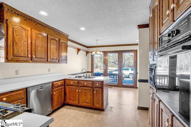 kitchen with a peninsula, brown cabinetry, stainless steel dishwasher, and hanging light fixtures