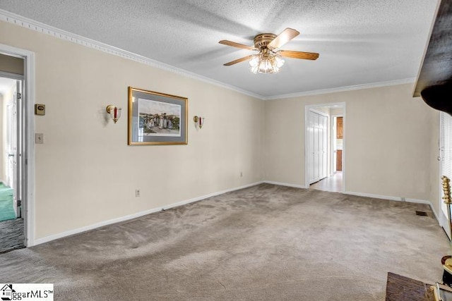 unfurnished room featuring a textured ceiling, carpet floors, and ornamental molding