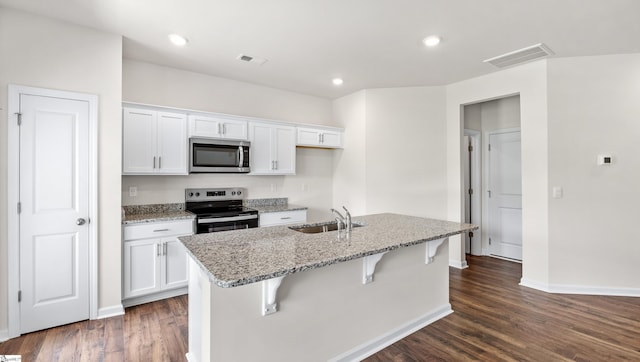 106 Sunriff Ct, Greer, SC 29651 - kitchen featuring stainless steel appliances, white cabinetry, an island with sink, light stone countertops, and recessed lighting