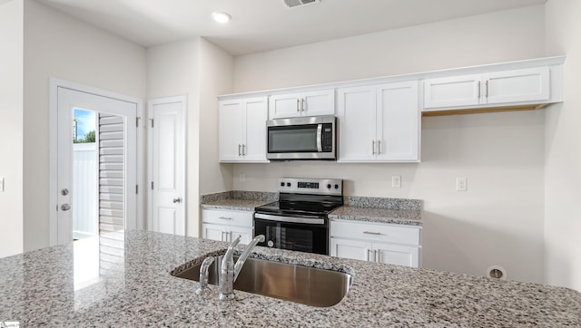 106 Sunriff Ct, Greer, SC 29651 - kitchen featuring appliances with stainless steel finishes, white cabinetry, and light stone countertops