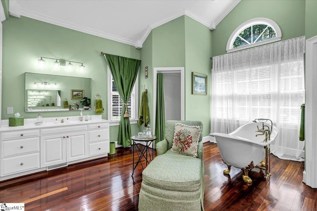 sitting room featuring dark wood-style floors, baseboards, ornamental molding, and vaulted ceiling