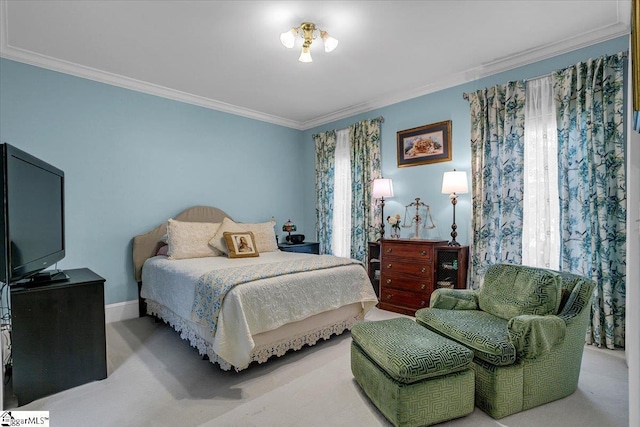 carpeted bedroom with ornamental molding and baseboards