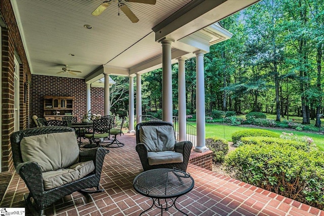 view of patio with outdoor dining area and a ceiling fan