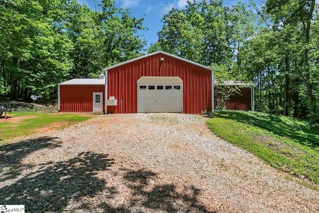 detached garage with gravel driveway