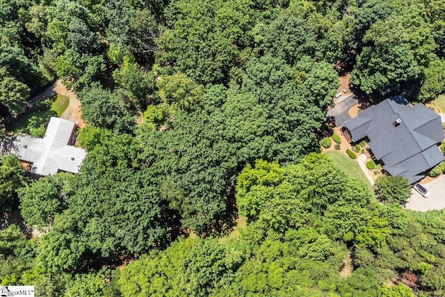 aerial view featuring a wooded view