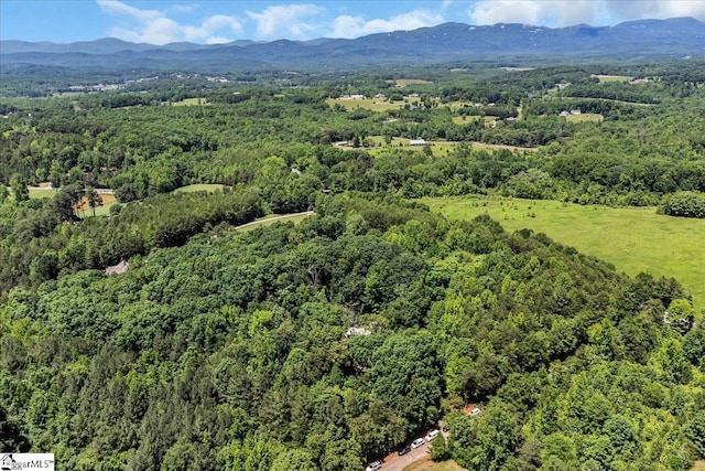 bird's eye view featuring a forest view and a mountain view