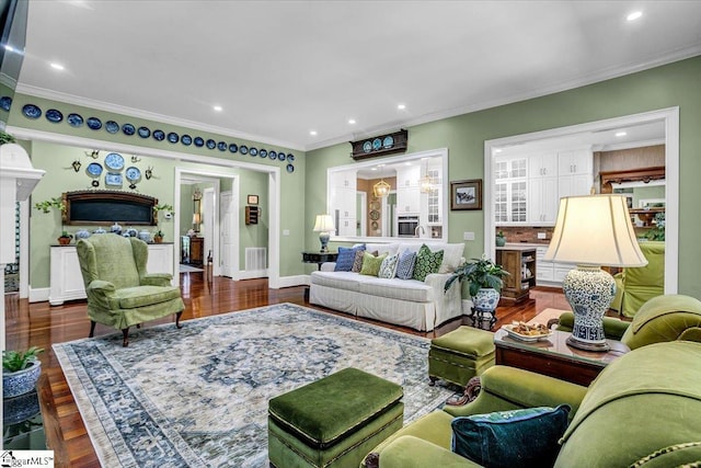 living room with baseboards, visible vents, ornamental molding, dark wood-type flooring, and recessed lighting