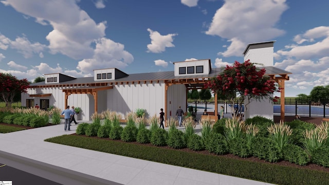 contemporary house featuring metal roof, fence, a pergola, and board and batten siding